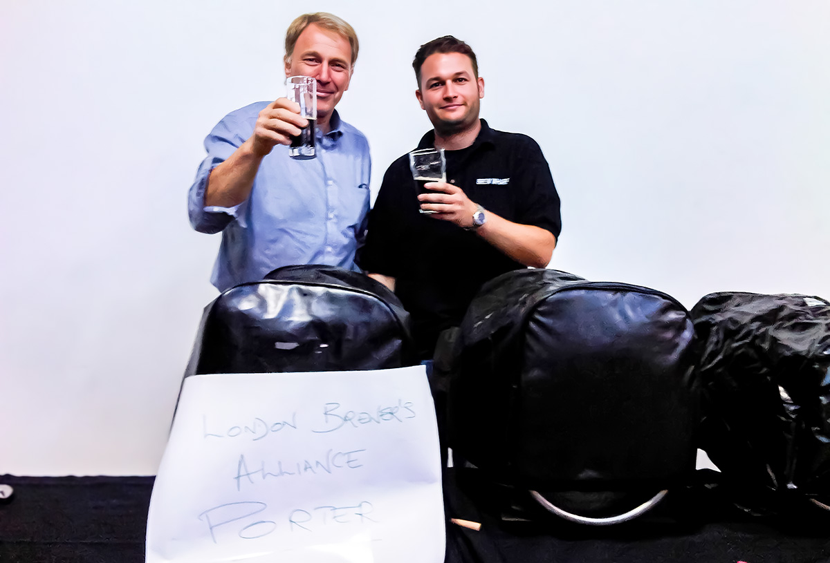 Derek Prentice & Phil Lowry raise a glass of London Brewers Alliance Porter together, stood behind jacketed casks at the very first London Brewers Showcase in September 2010.